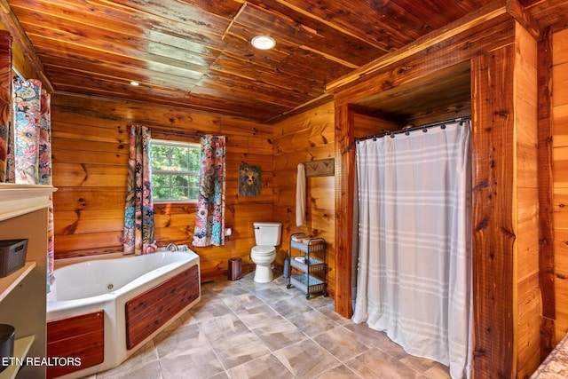 bathroom featuring vanity, wood walls, wooden ceiling, toilet, and a washtub