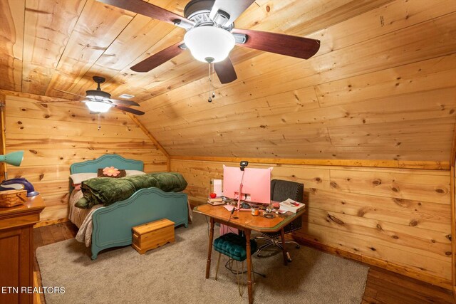 bedroom featuring wooden walls, wooden ceiling, vaulted ceiling, hardwood / wood-style floors, and ceiling fan