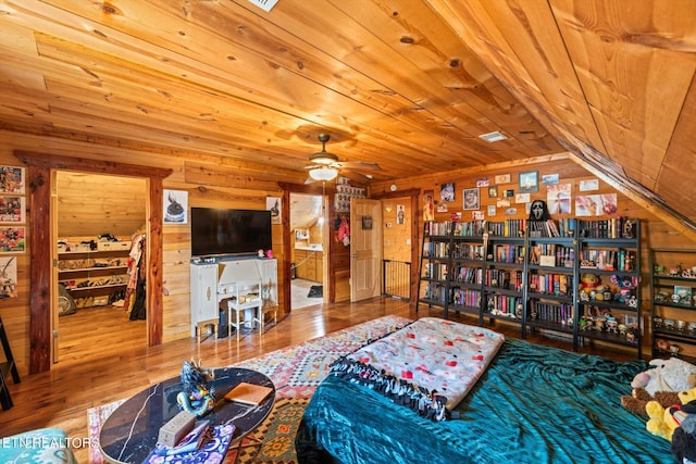 bedroom with wood ceiling, hardwood / wood-style floors, and wooden walls