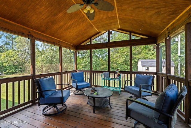 sunroom / solarium featuring lofted ceiling, ceiling fan, and wood ceiling