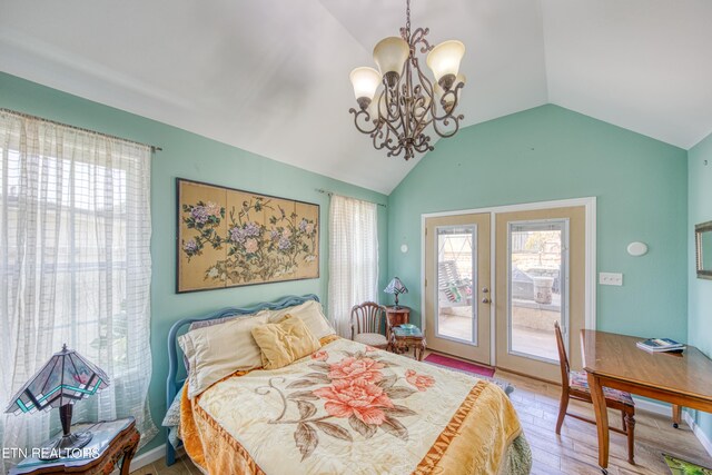 bedroom featuring french doors, light wood-type flooring, a chandelier, lofted ceiling, and access to exterior