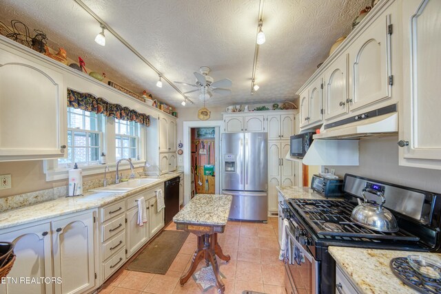 kitchen with sink, track lighting, black appliances, ceiling fan, and a textured ceiling