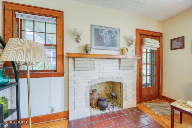 interior space with a fireplace and a textured ceiling