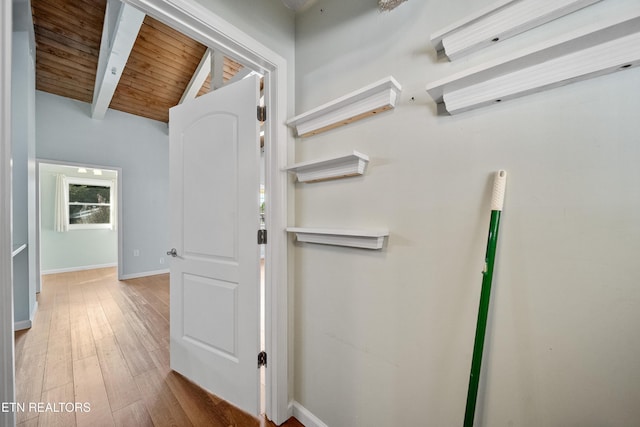 corridor featuring vaulted ceiling with beams, wood ceiling, and light hardwood / wood-style floors