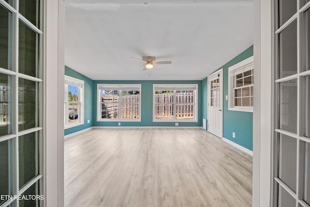 unfurnished sunroom featuring lofted ceiling and ceiling fan