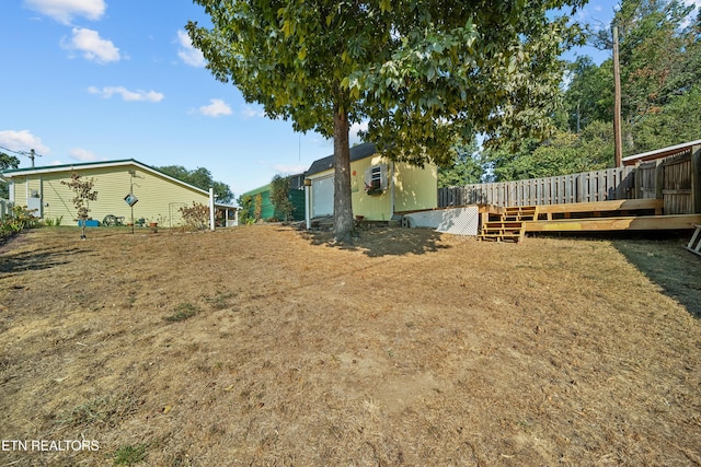 view of yard with a wooden deck