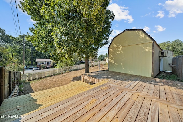 wooden terrace featuring a storage shed