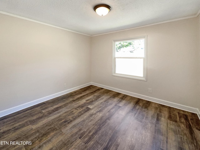 spare room featuring baseboards, dark wood-type flooring, and a textured ceiling