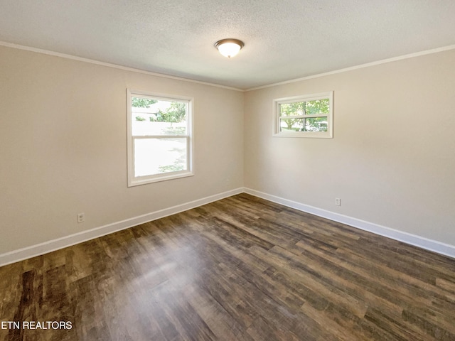 empty room featuring baseboards, a textured ceiling, dark wood finished floors, and crown molding