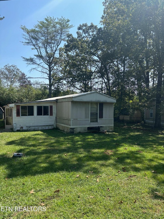 back of house with a lawn