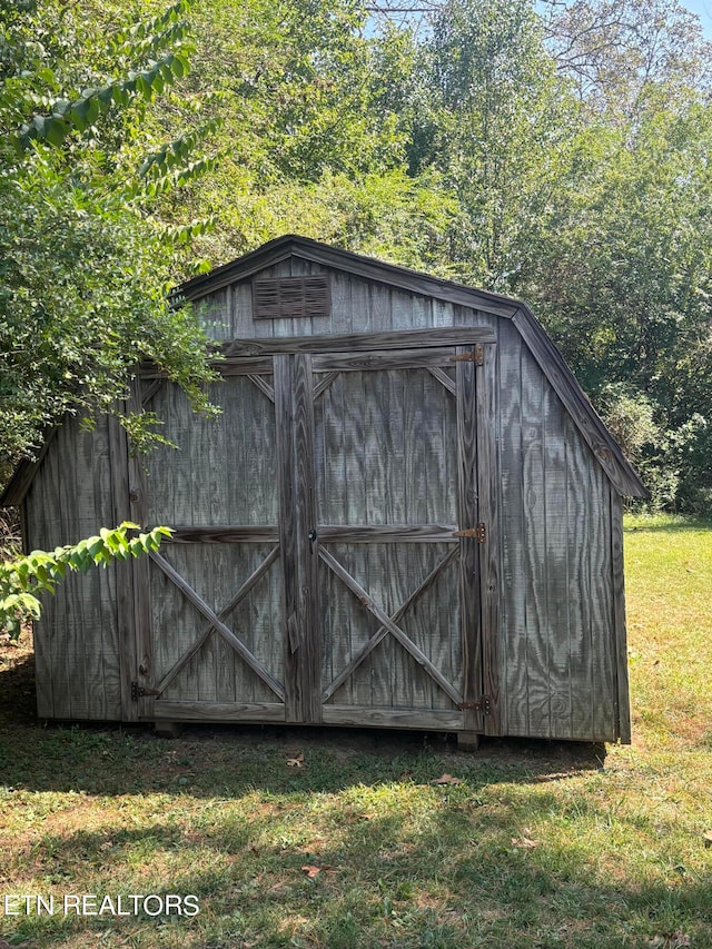 view of outbuilding with a lawn