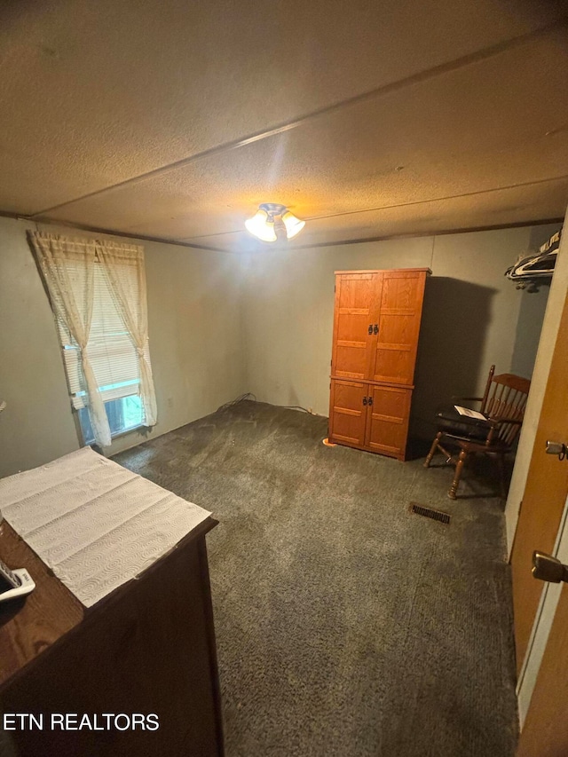 carpeted bedroom featuring a textured ceiling