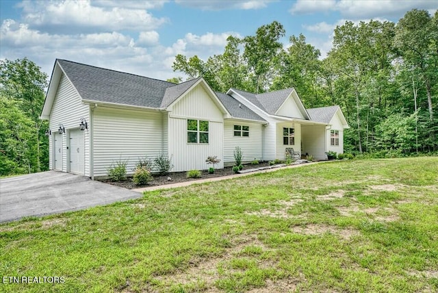 ranch-style home featuring a garage and a front yard