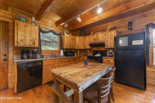 kitchen featuring light wood-type flooring, track lighting, sink, black appliances, and range hood