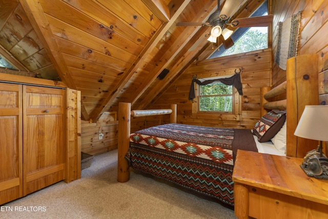 bedroom featuring wooden walls, lofted ceiling with beams, ceiling fan, and wooden ceiling