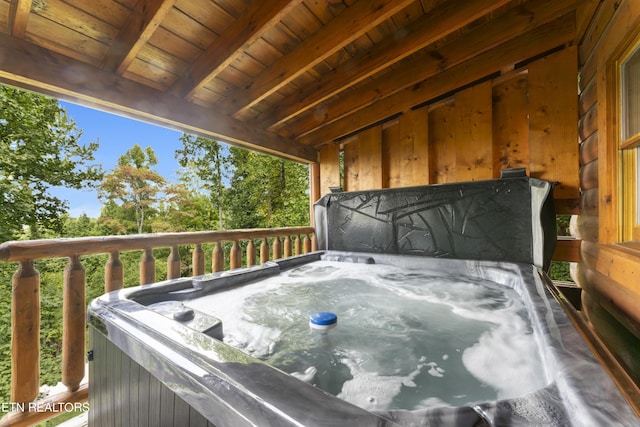 wooden deck featuring a hot tub