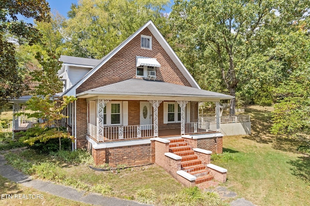 view of front facade with a front yard and a porch