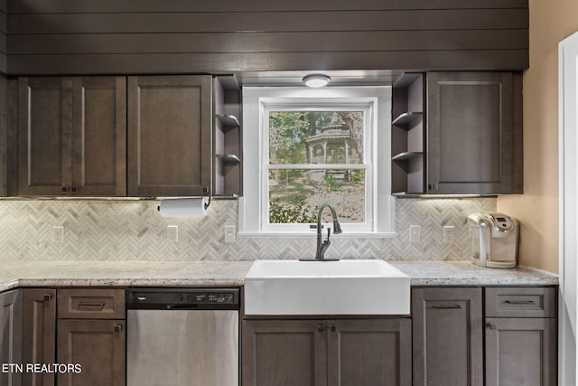 kitchen featuring light stone countertops, dishwasher, tasteful backsplash, and sink