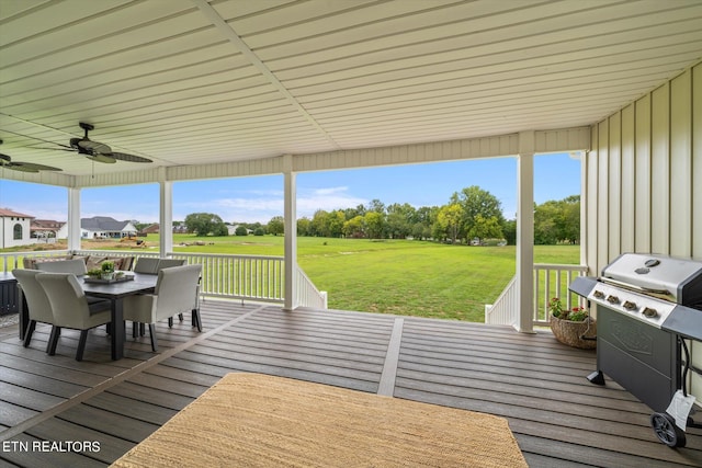 wooden deck with a grill, a yard, and ceiling fan