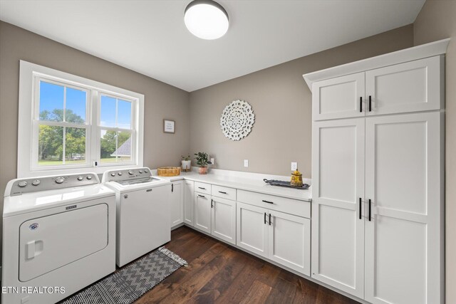 washroom featuring washing machine and clothes dryer, cabinets, and dark wood-type flooring