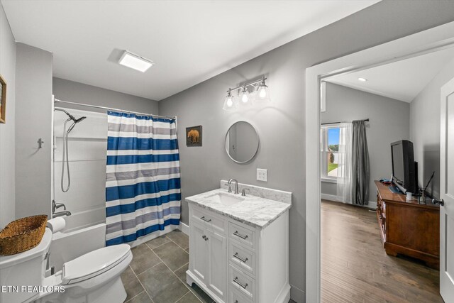 full bathroom with vanity, wood-type flooring, toilet, shower / bathtub combination with curtain, and lofted ceiling