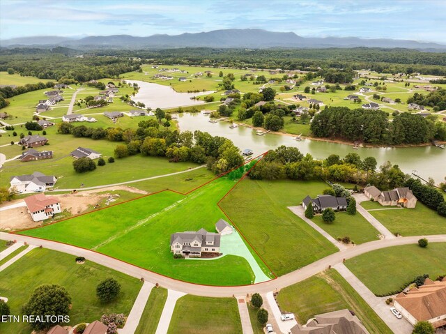 drone / aerial view with a water and mountain view