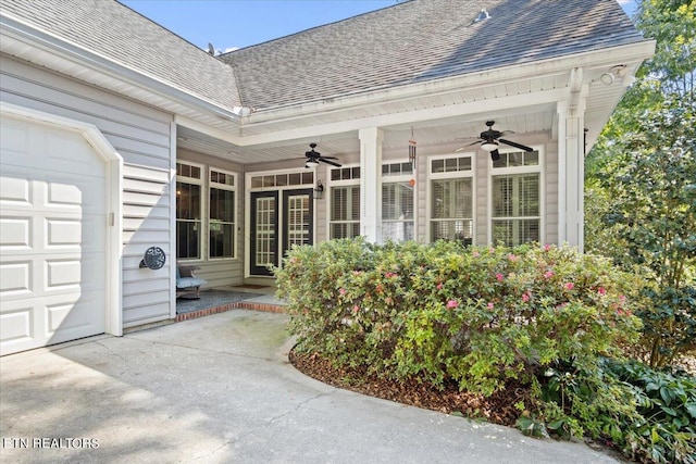 property entrance featuring ceiling fan and a garage