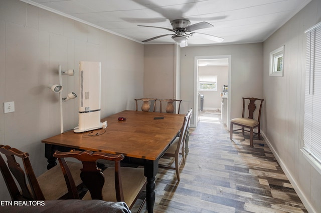 dining space featuring ceiling fan, hardwood / wood-style flooring, and crown molding