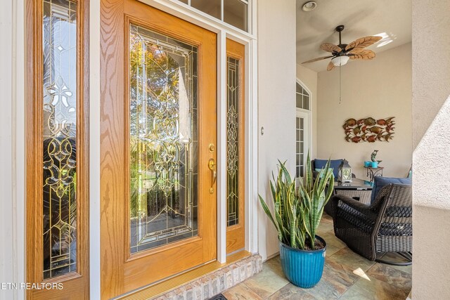 property entrance with ceiling fan