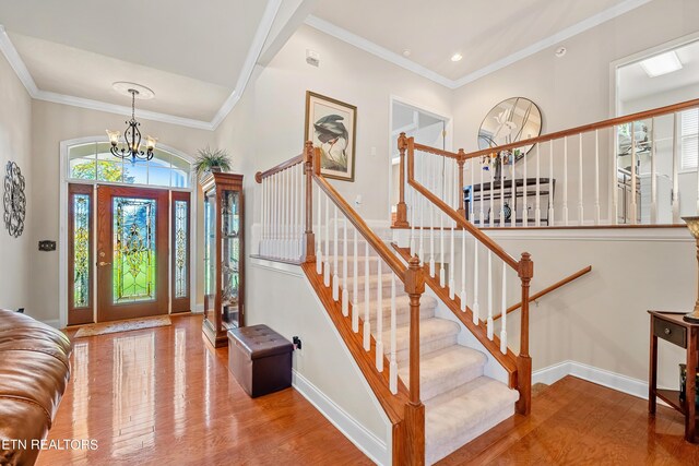 155 Killdeer Dr, Vonore, TN 37885 - entryway featuring crown molding, baseboards, stairs, wood finished floors, and a notable chandelier