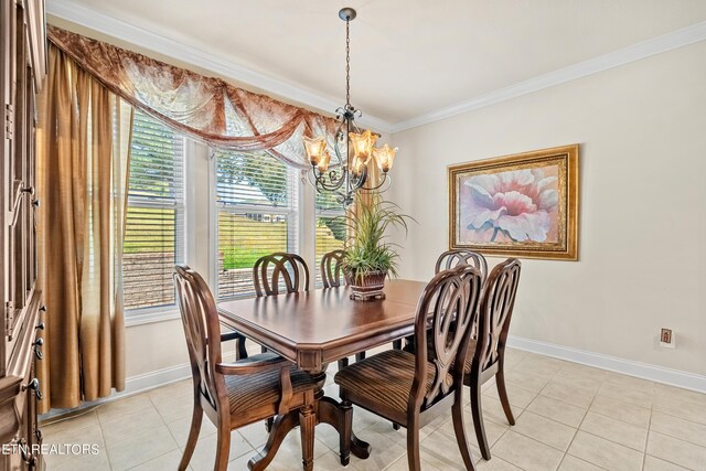 dining space with light tile patterned floors, a chandelier, and crown molding