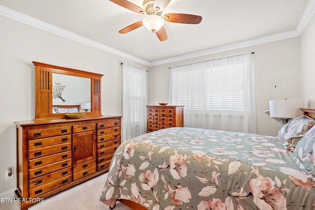 bedroom featuring ornamental molding, light carpet, and ceiling fan