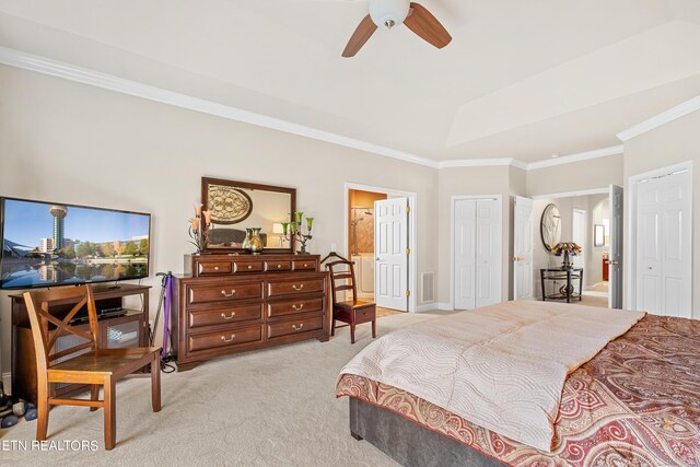 bedroom featuring light colored carpet, lofted ceiling, ceiling fan, connected bathroom, and ornamental molding