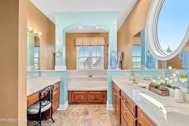 bathroom with a tub to relax in and vanity