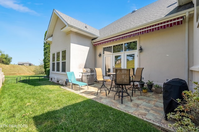155 Killdeer Dr, Vonore, TN 37885 - back of house with a lawn, stucco siding, a patio area, and roof with shingles