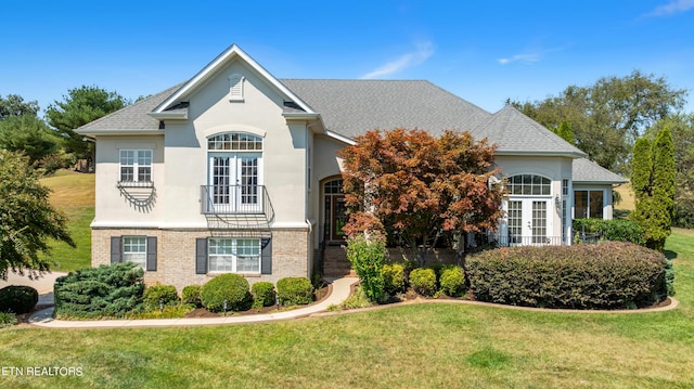155 Killdeer Dr, Vonore, TN 37885 - traditional home featuring stucco siding, brick siding, french doors, and a front yard