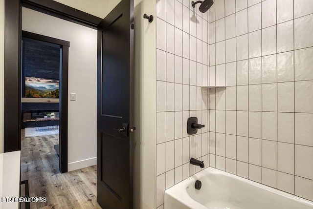 bathroom featuring tiled shower / bath combo and hardwood / wood-style floors