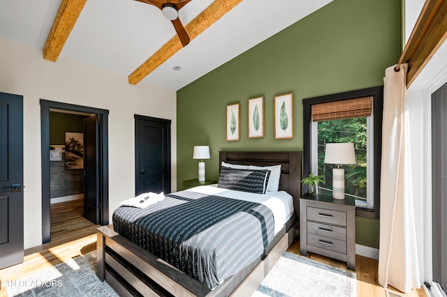 bedroom featuring light wood-type flooring, ceiling fan, and lofted ceiling with beams