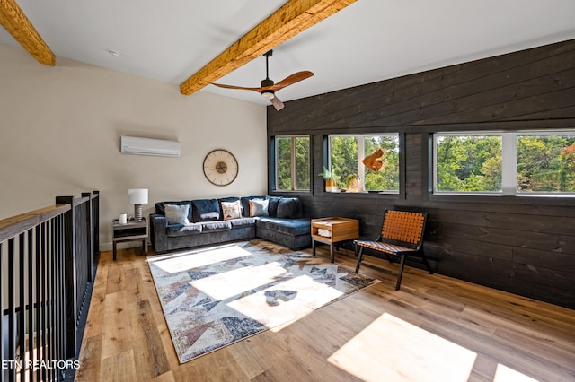 living room with wood walls, ceiling fan, light hardwood / wood-style floors, and an AC wall unit