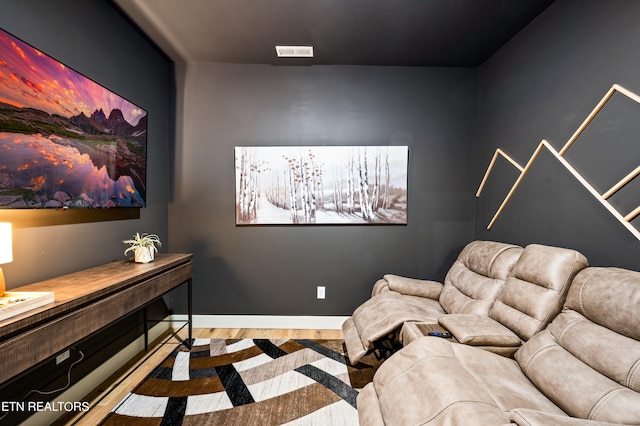 home theater room with light wood-type flooring