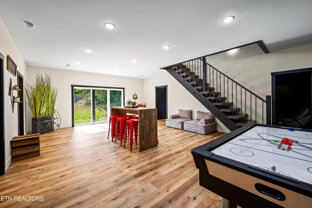 game room with light hardwood / wood-style flooring