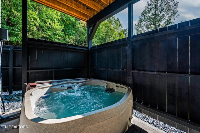 view of swimming pool with a hot tub