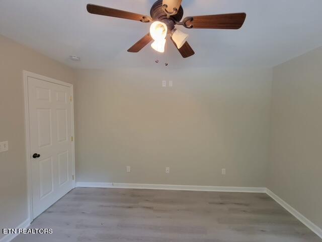 spare room featuring ceiling fan and wood-type flooring