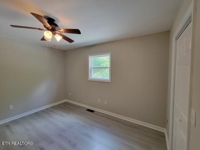 unfurnished bedroom featuring hardwood / wood-style floors and ceiling fan