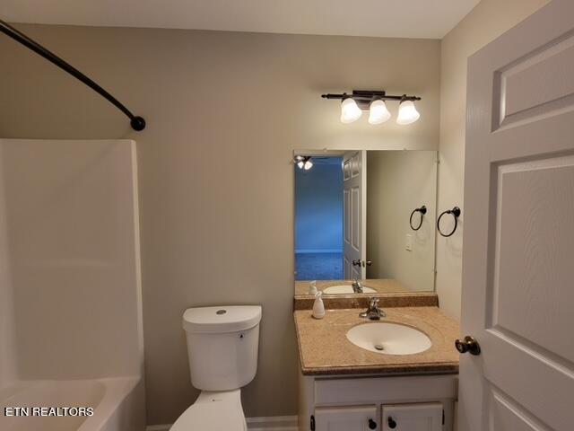 full bathroom featuring toilet, tub / shower combination, and vanity