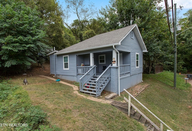 bungalow-style house with a porch and a front yard