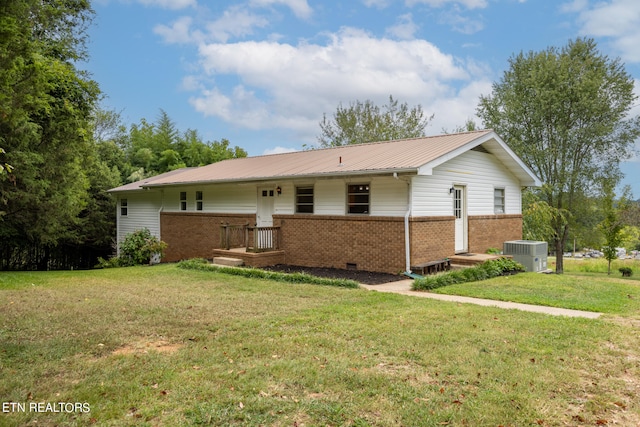 view of front of home featuring a front lawn and central air condition unit