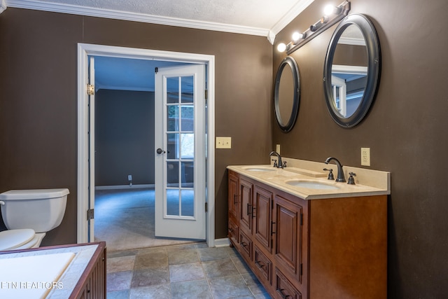 bathroom with crown molding, vanity, toilet, and a textured ceiling