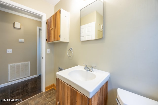 bathroom featuring vanity, toilet, and tile patterned flooring