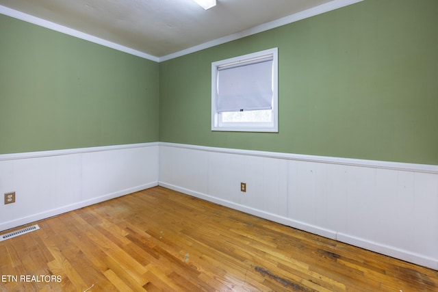 unfurnished room featuring crown molding and light hardwood / wood-style flooring